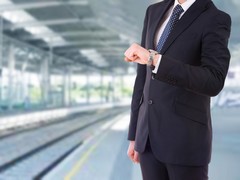 Businessman checking time on his wristwatch.